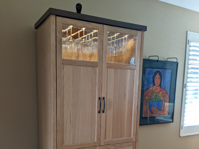 Custom Shaker Dry Bar Armoire with Stemware Holder. Crown Molding. Done in Natural Stain and Espresso Accents on White Oak.