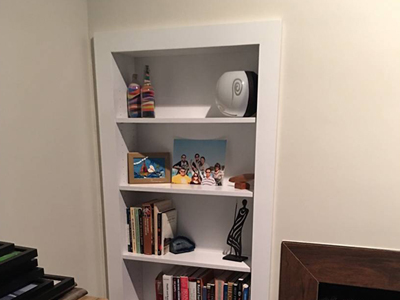 Custom Built-in Bookcases-Shelves Disguised as a Hidden Door shown in Solid Bright White on Maple