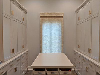 Custom Shaker Crafting Table/Desk and Storage Cabinets in Mudroom Shown in Off White on Maple