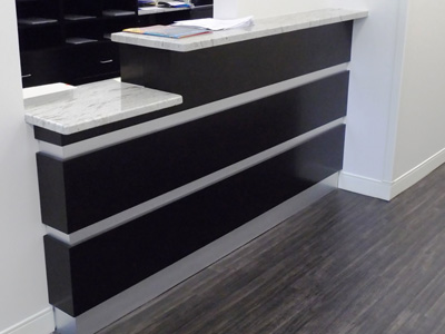 Commercial Check-Out Desk shown in Dark Espresso and Laminate Metal Accent Décore