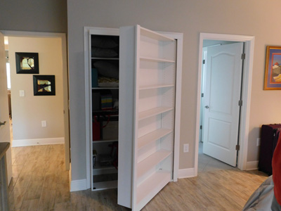 Custom Built-In Open Bookcases-Shelves Conceals a Hidden Closet shown in Solid Bright White on Maple