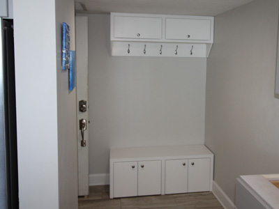 Custom Built-In Coat Hangers with Storage Hutch & Storage Bench for Mudroom shown in Solid Bright White on Maple
