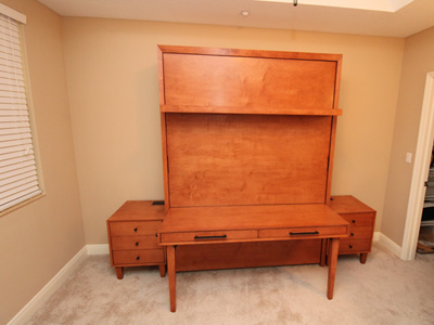 Siena Vertical Queen Murphy Wall Bed with 7” Shelf Leg, Custom Nightstands, Custom Mission Desk attached to Face of Bed shown in Cinnamon on Maple