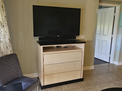 Custom Shaker TV Console with Media Opening, Flat Drawers and Finger Pulls shown in Two-Tone Finish Natural and Java on Maple