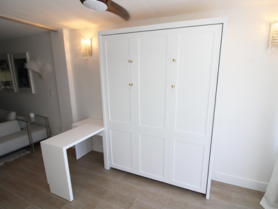 Custom Shaker Panel Murphy Wall Bed with Hidden Leg, Left Side Swing-Out Table on Nightstand Cabinet Shown in Solid Bright White on Maple with Custom Cabinet Pulls