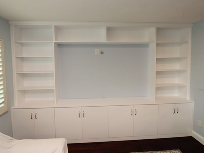 Custom Modern Entertainment Center Floor-to-Ceiling, Wall-to-Wall, Adjustable Shelves, Flat Doors, Crown Molding shown in Bright White on Maple (144 1/4