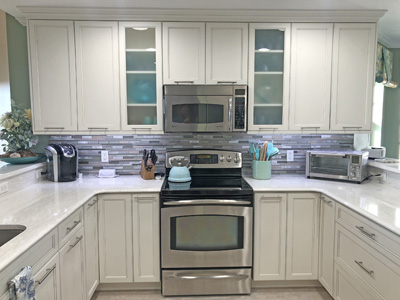 Custom Kitchen Mission Cabinets and Banquette, Quartz Countertops, Nickel Bar Pulls, Tile Aluminum Backsplash shown in Custom Greek Villa Finish and Gray Glazing on Maple