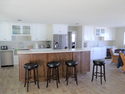 Custom White Shaker Kitchen Cabinets and Quartz Countertops with Custom Two-Tone Island shown in Bright White on Maple and Custom Stain on Oak