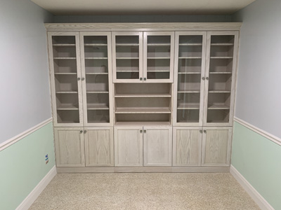 Custom Shaker Wall-to-Wall Built-In Display Cabinets with Wood Frame Glass Doors shown in Whitewash on Oak