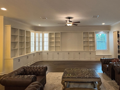 Custom Built-In Mission Entertainment Center with Window Seat shown in Aged White on Maple
