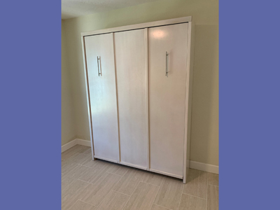 Savona Queen Vertical Murphy Wall Bed with Vertical Face Trim, Flip Down Legs with 2 Nickel Bar Handles shown in Whitewash on Oak