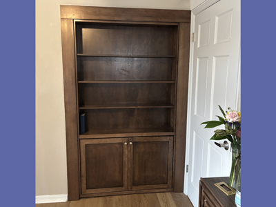 Custom Solid Maple Bookcase Hidden Murphy Door with 2 Shaker Doors on Bottom with Flat Trim and Tall Bottom Base shown in Walnut Stain
