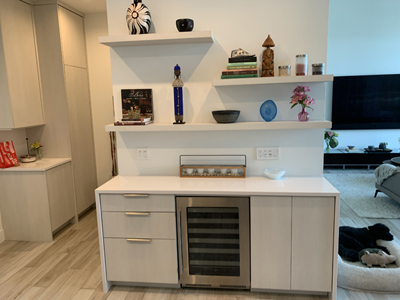 Custom Modern Dry Bar with Floating Shelves and Wine Fridge shown in Phantom Pearl Melamine to Match Kitchen