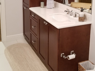 Custom Mission Bathroom Vanity and Linen Pier Cabinet shown in Mahogany on Maple
