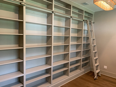 Custom Built-In Wall to Wall Open Library Bookcase and Sliding Ladder with Adjustable Shelves shown in Amazing Gray on Maple