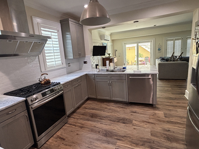 Custom Kitchen Shaker Cabinets and Pantry shown in Soft Gray on Oak with Nickel Arch Pulls