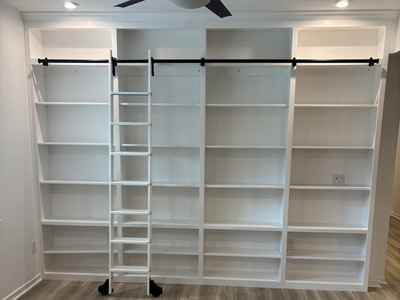Custom Shaker Open Bookcases and Sliding Library Ladder with Crown Molding and Adjustable Shelves Shown in Bright White on Maple