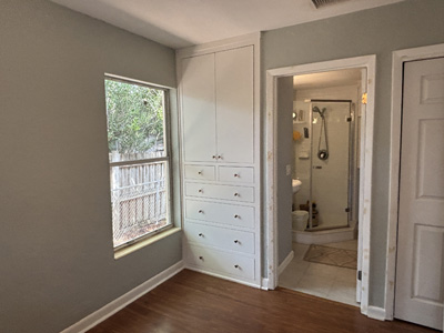 Custom Built-In Wardrobe Closet with Upper Cabinets and Lower Drawers shown in Greek Villa on Maple with Champagne Bronze Knobs